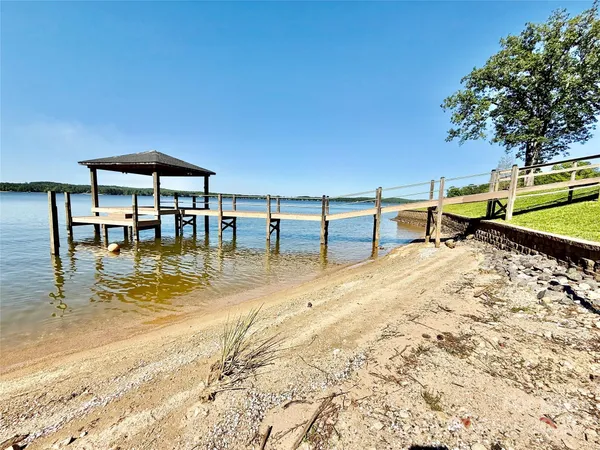 a view of a lake with a table and chairs