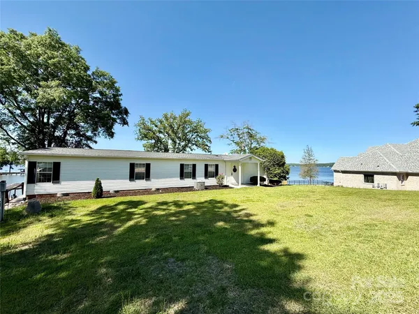 a front view of house with yard and trees