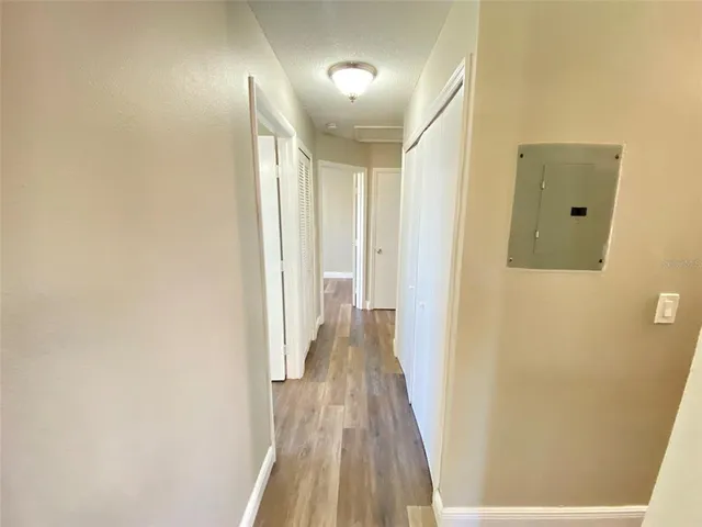 a view of a hallway with wooden floor