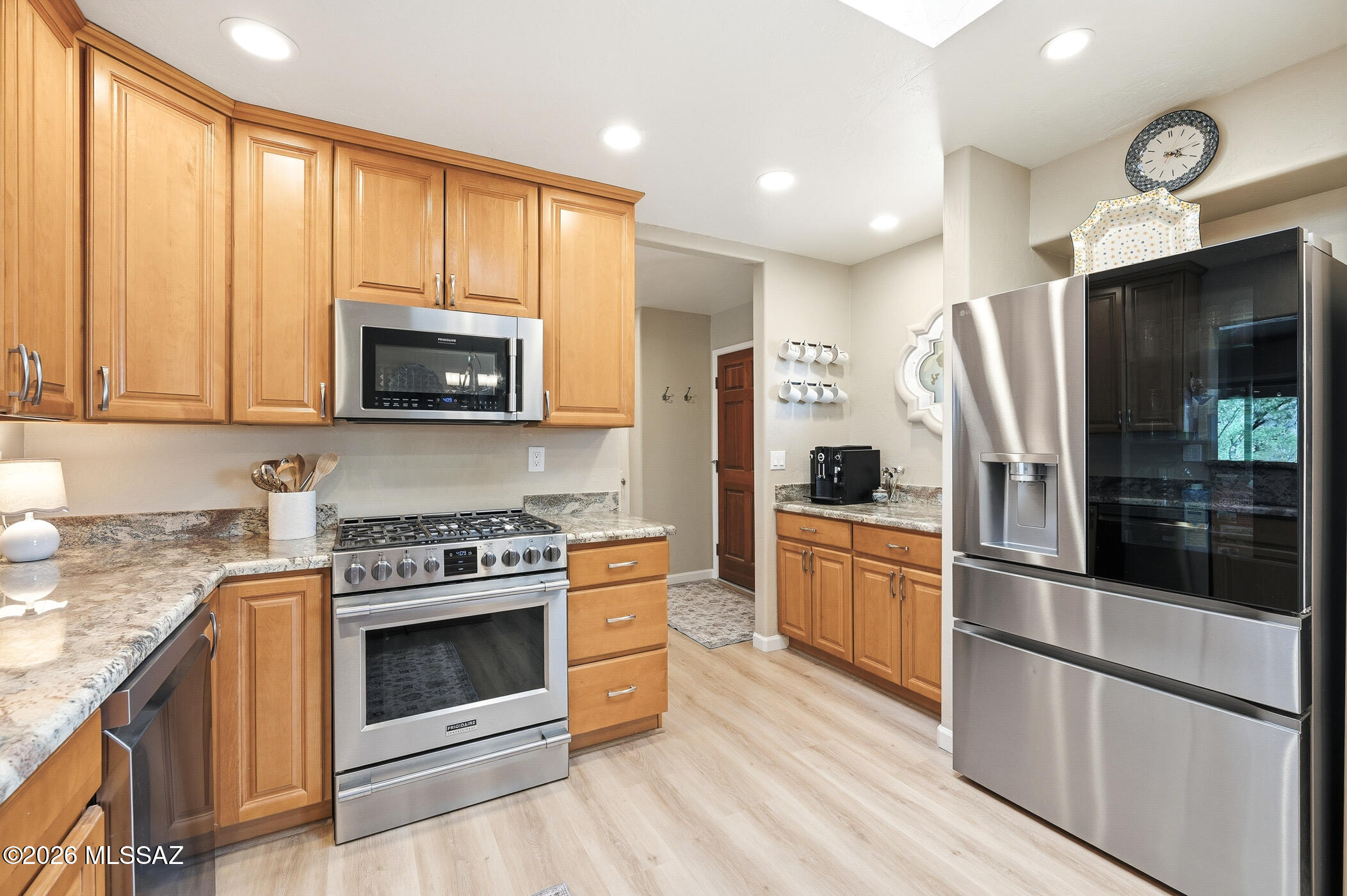 13599 East Rincon Ranch Road Vail, AZ 85641 - Photo 15 of 41 a kitchen with stainless steel appliances granite countertop a stove a refrigerator and a microwave