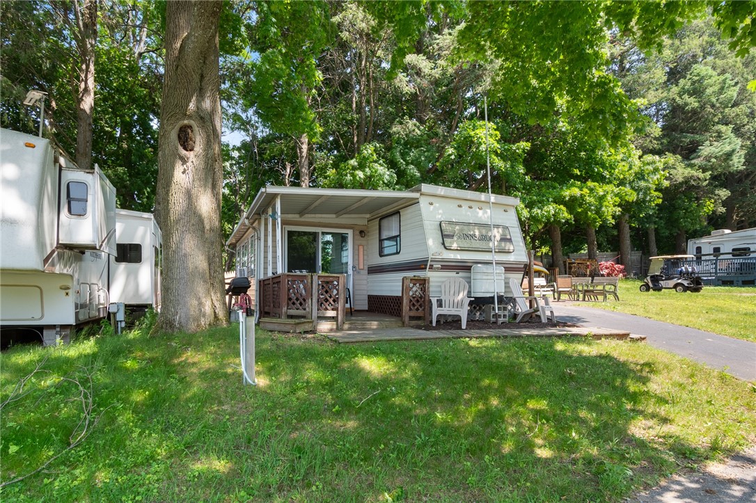 7945 Lake Road, Unit 129 Sodus, NY 14555 - Photo 3 of 22 A comfortable seating area outside- a quiet book-