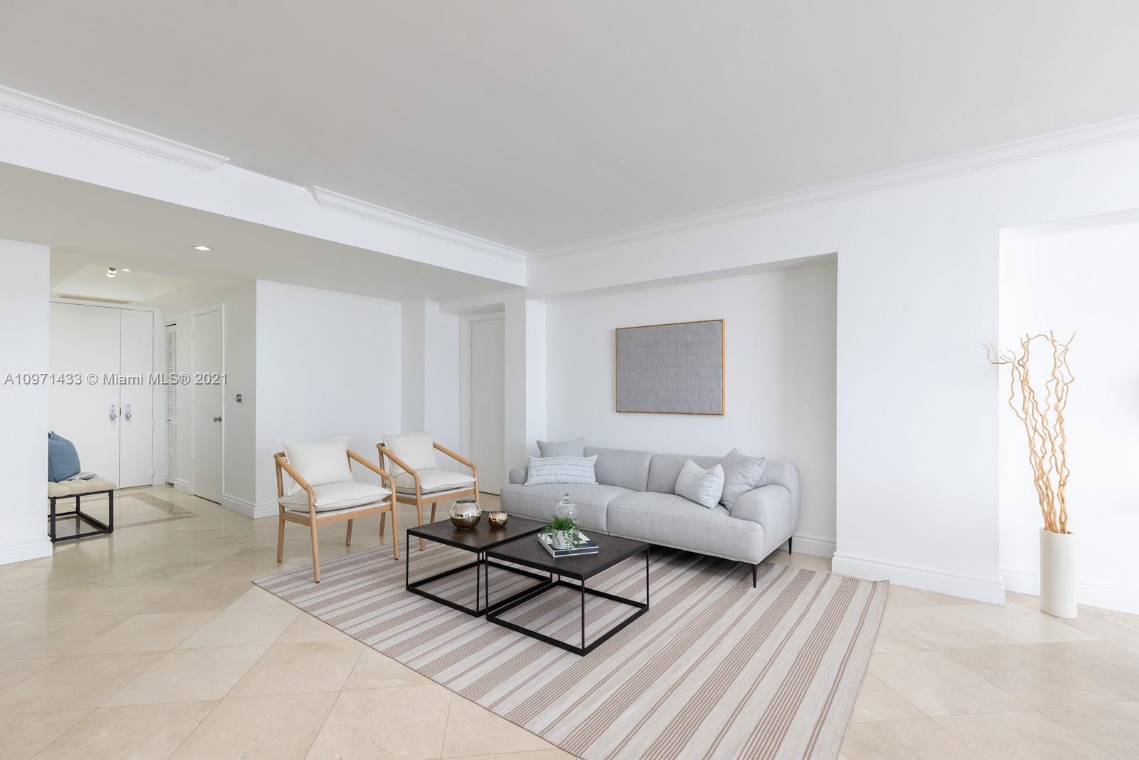 848 Brickell Key Drive, Unit 904 Miami, FL 33131 - Photo 11 of 31 a living room with furniture and a table