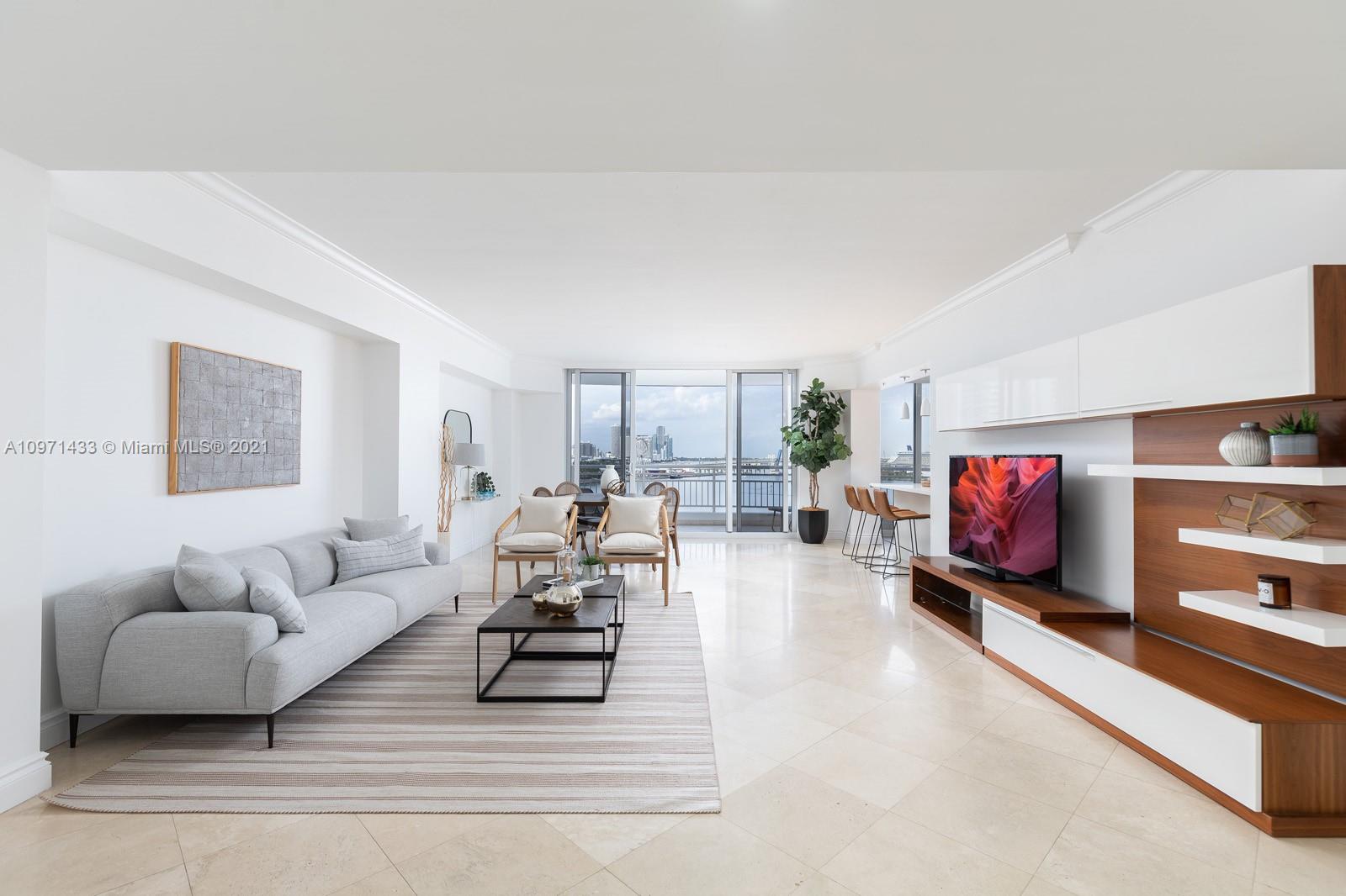848 Brickell Key Drive, Unit 904 Miami, FL 33131 - Photo 8 of 31 a living room with furniture and a flat screen tv