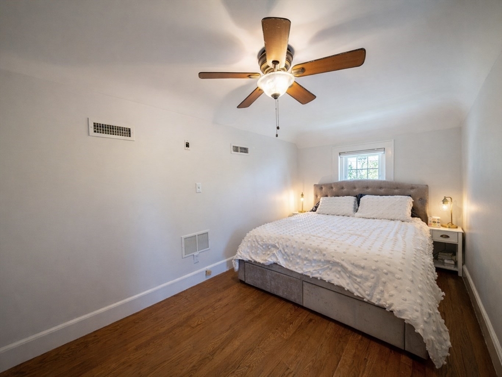 10 Guild Road Saugus, MA 01906 - Photo 23 of 32 a bedroom with a bed and a chandelier