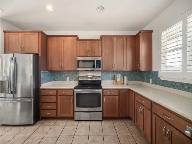 a kitchen with a stove sink and refrigerator
