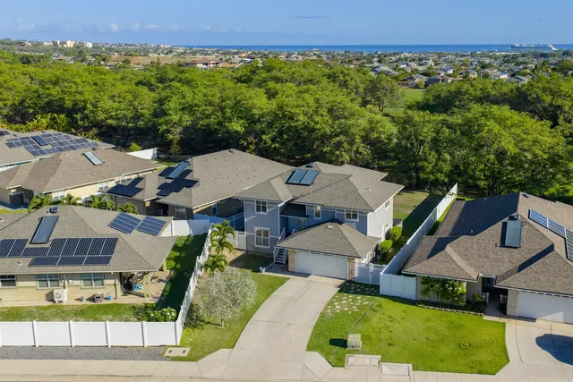an aerial view of a house with garden space and street view