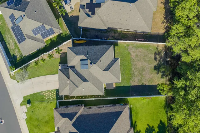 an aerial view of a house with a yard
