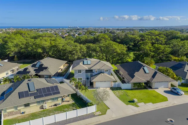 an aerial view of residential houses with outdoor space and street view