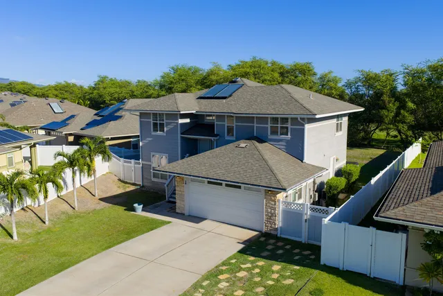 an aerial view of a house with swimming pool garden and patio