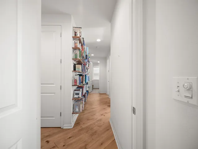 a view of a hallway with wooden shelves