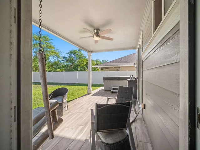 a living room with a floor to ceiling window and wooden floor