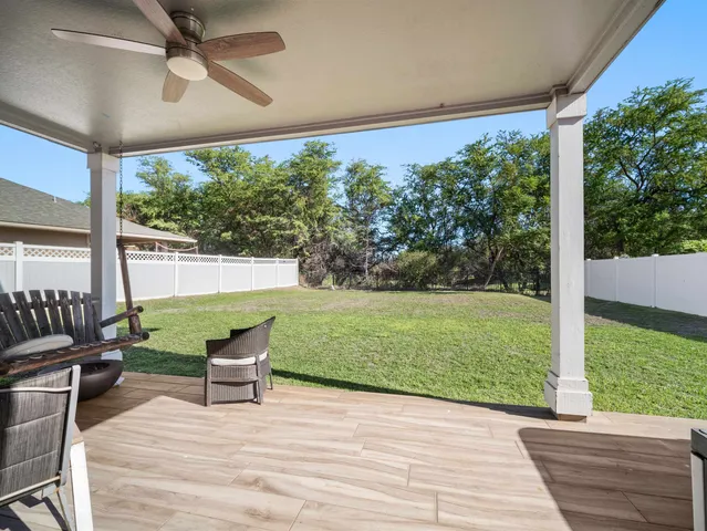 a view of a patio with a yard
