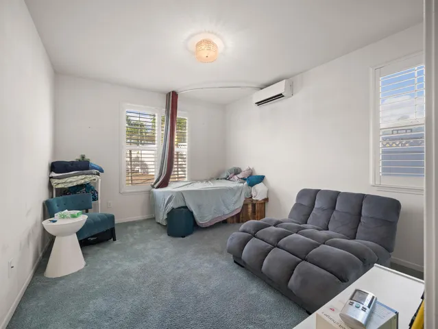 a living room with furniture a ceiling fan and a window