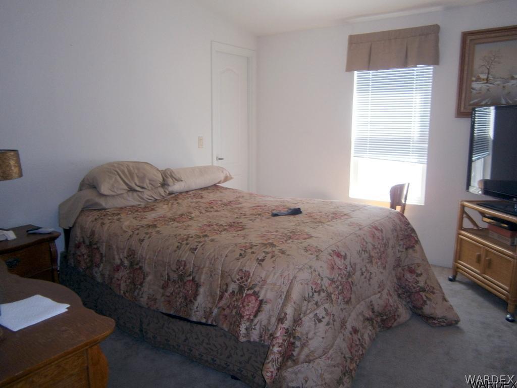13411 South Water Reed Way, Unit 3 Topock, AZ 86436 - Photo 13 of 16 a bed sitting in a bedroom next to a window