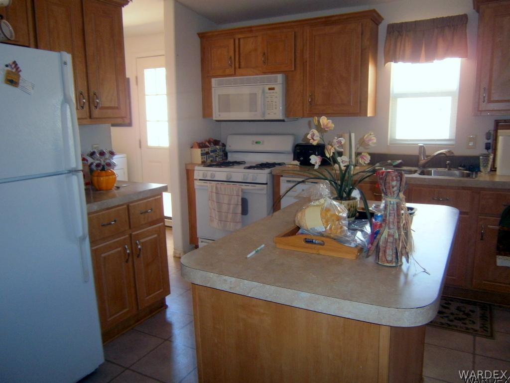 13411 South Water Reed Way, Unit 3 Topock, AZ 86436 - Photo 8 of 16 a kitchen with refrigerator and window