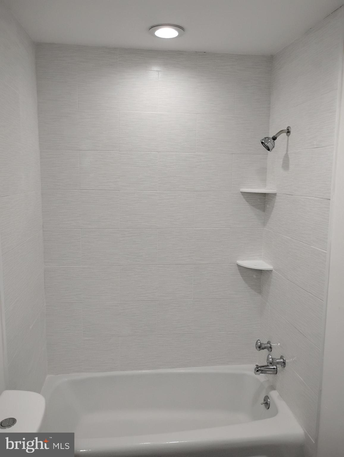 8435 Greenbelt Road, Unit 202 Greenbelt, MD 20770 - Photo 14 of 20 a bathroom with a shower