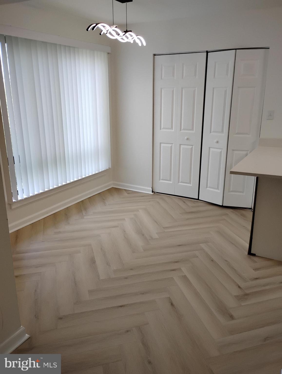 8435 Greenbelt Road, Unit 202 Greenbelt, MD 20770 - Photo 9 of 20 a view of an empty room with wooden floor