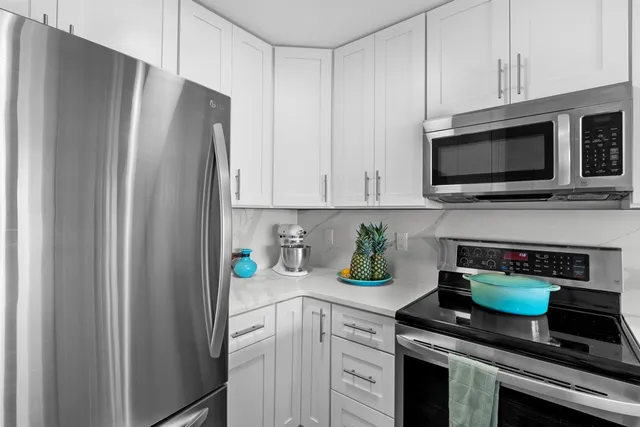 a kitchen with sink and view of living room