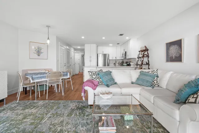 a bedroom with a bed chandelier and a window