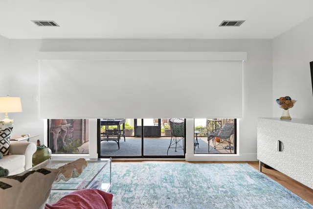 a living room with a furniture and a flat screen tv