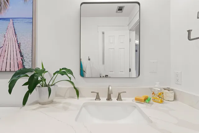 a view of a porch with a table and chairs