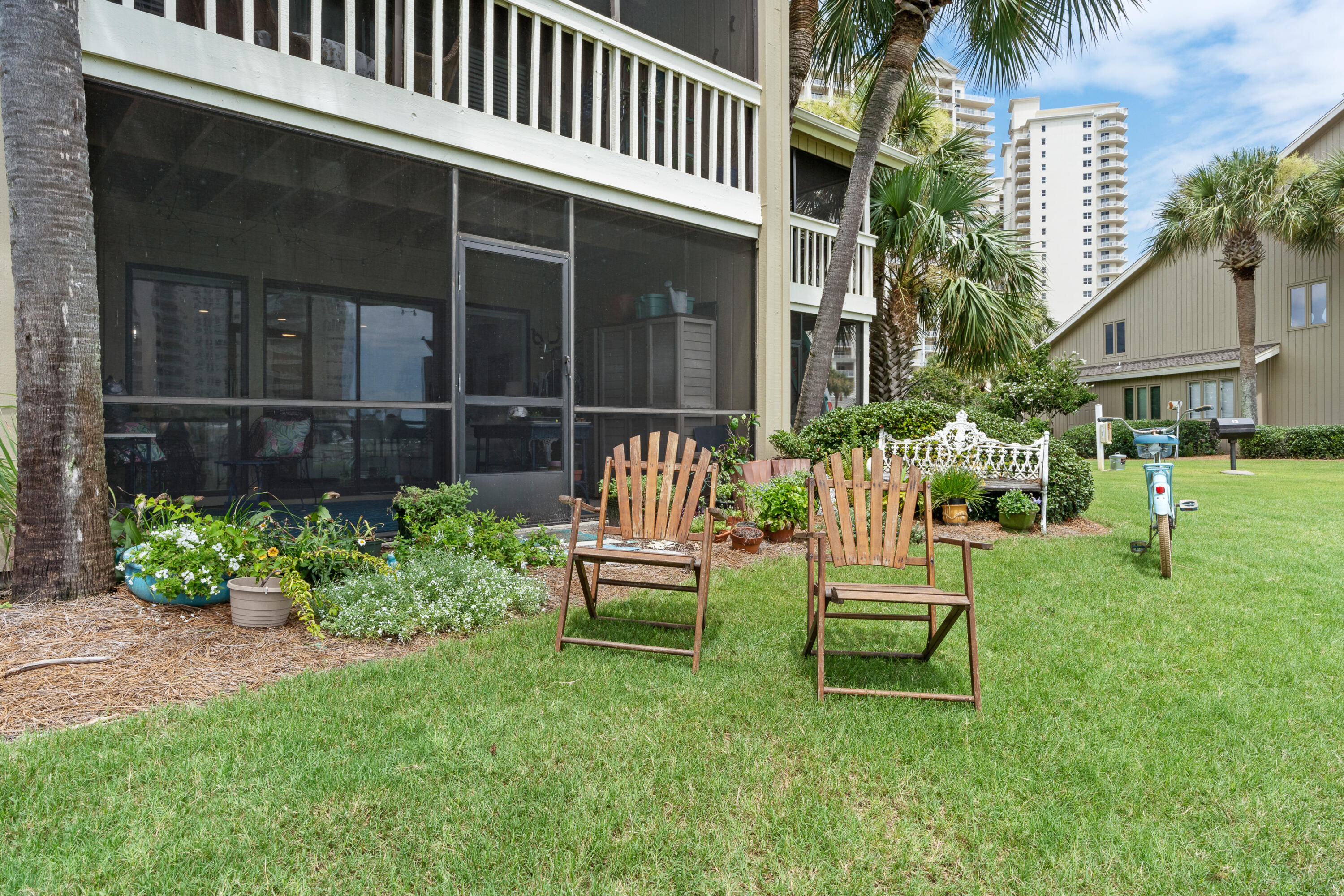 48 Stewart Lake Cove, Unit 194 Miramar Beach, FL 32550 - Photo 42 of 57 a garden with a bench in front of the house
