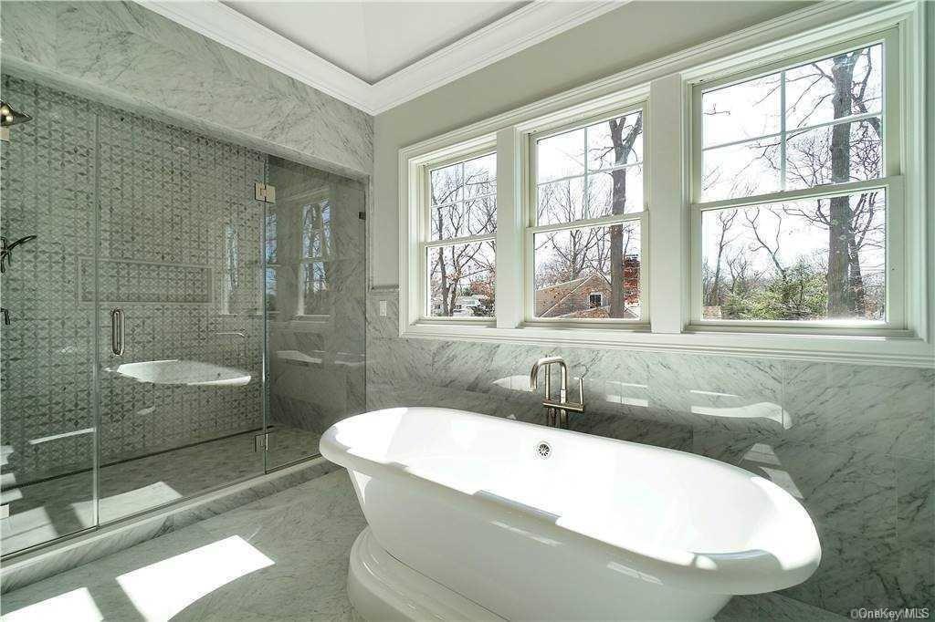 Lot 4 Wading River Road Manorville, NY 11949 - Photo 21 of 28 Bathroom with crown molding, plus walk in shower, and tile walls. FOR MARKETING PURPOSES ONLY!