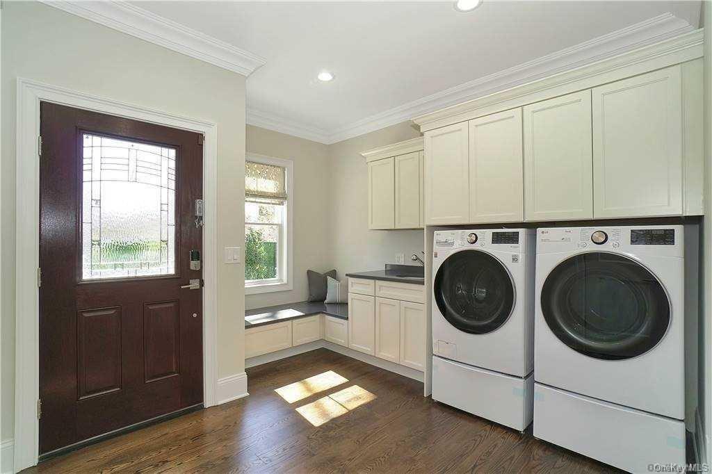 Lot 4 Wading River Road Manorville, NY 11949 - Photo 23 of 28 Laundry room with cabinets, dark hardwood / wood-style flooring, washing machine and dryer, and crown molding. FOR MARKETING PURPOSES ONLY!