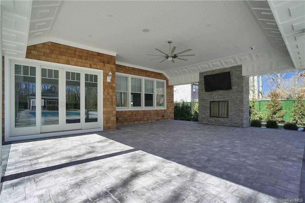 Lot 4 Wading River Road Manorville, NY 11949 - Photo 24 of 28 View of patio featuring ceiling fan, french doors, and an outdoor stone fireplace. FOR MARKETING PURPOSES ONLY!
