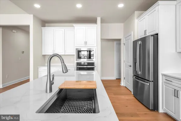 a kitchen with stainless steel appliances a refrigerator and a stove top oven