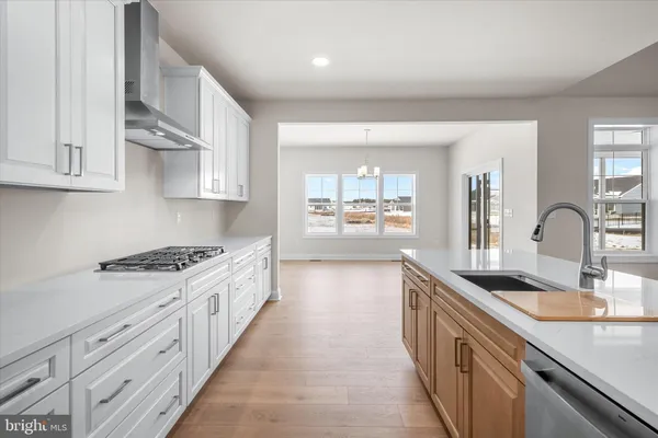 a kitchen with granite countertop a sink stove and cabinets