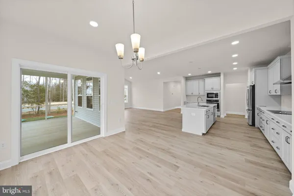 a view of a kitchen with a sink and wooden floor
