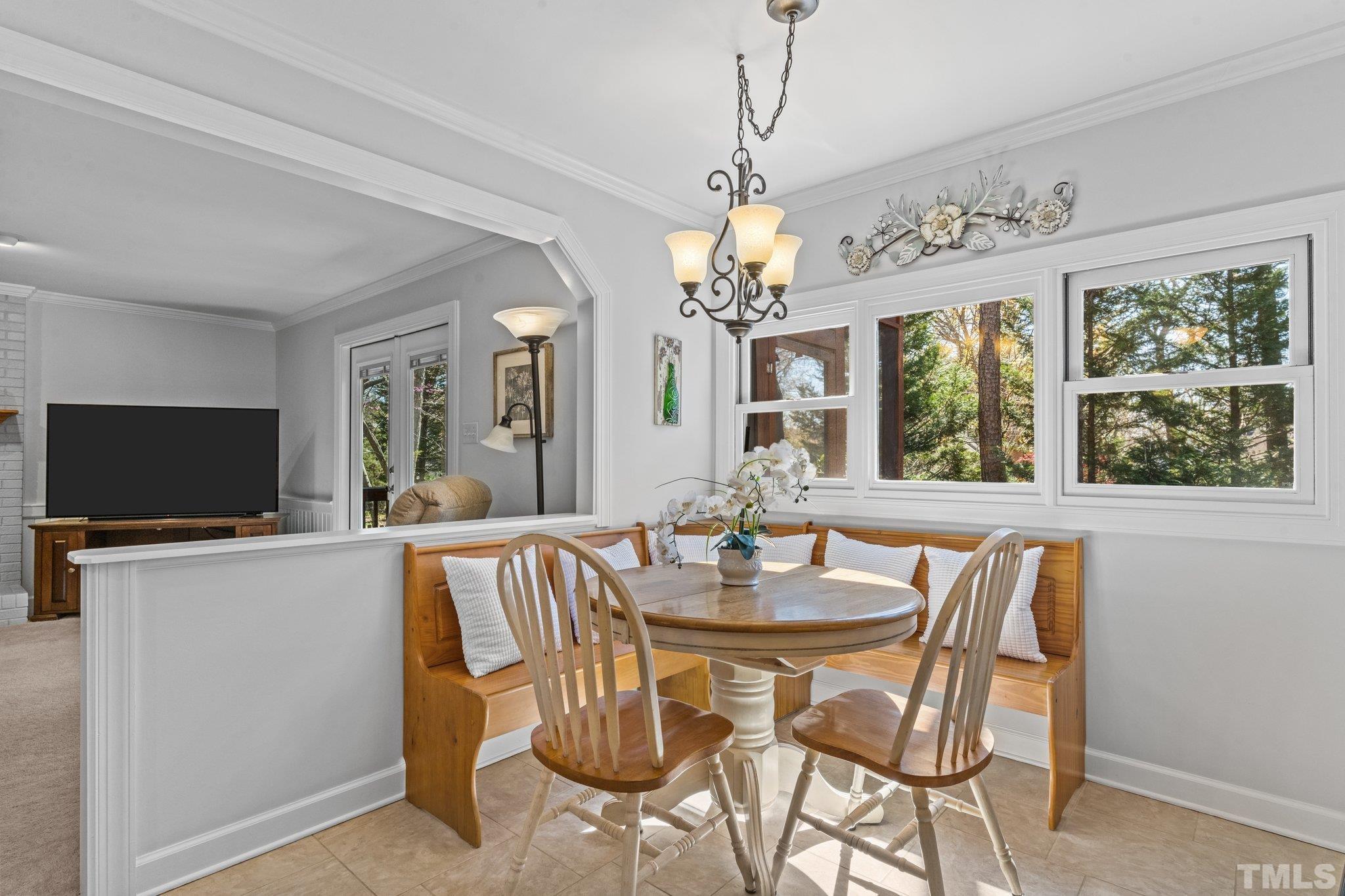 8325 Apple Orchard Way Raleigh, NC 27615 - Photo 13 of 54 a view of a dining room with furniture a chandelier and window