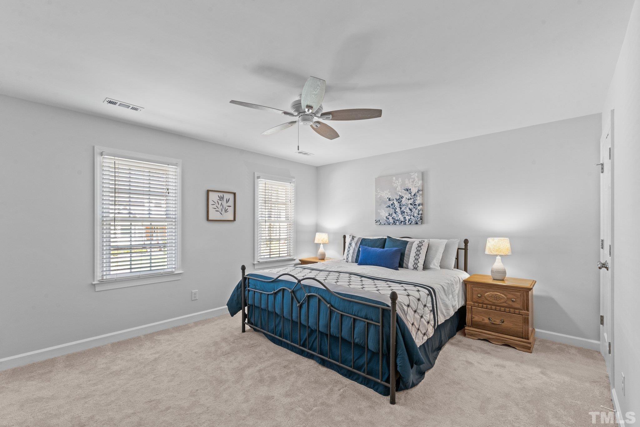8325 Apple Orchard Way Raleigh, NC 27615 - Photo 29 of 54 a bedroom with a bed chandelier and a window