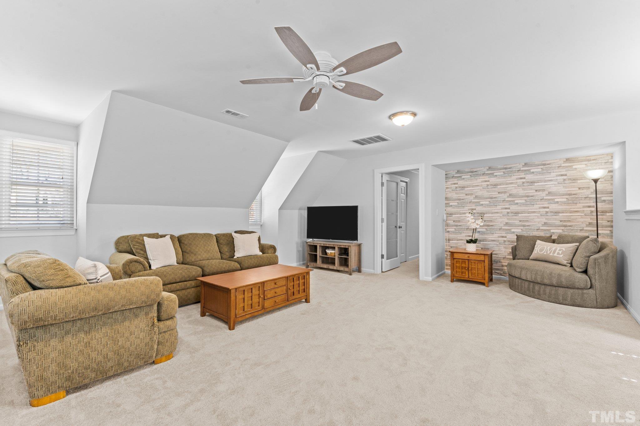 8325 Apple Orchard Way Raleigh, NC 27615 - Photo 33 of 54 a living room with furniture and a flat screen tv