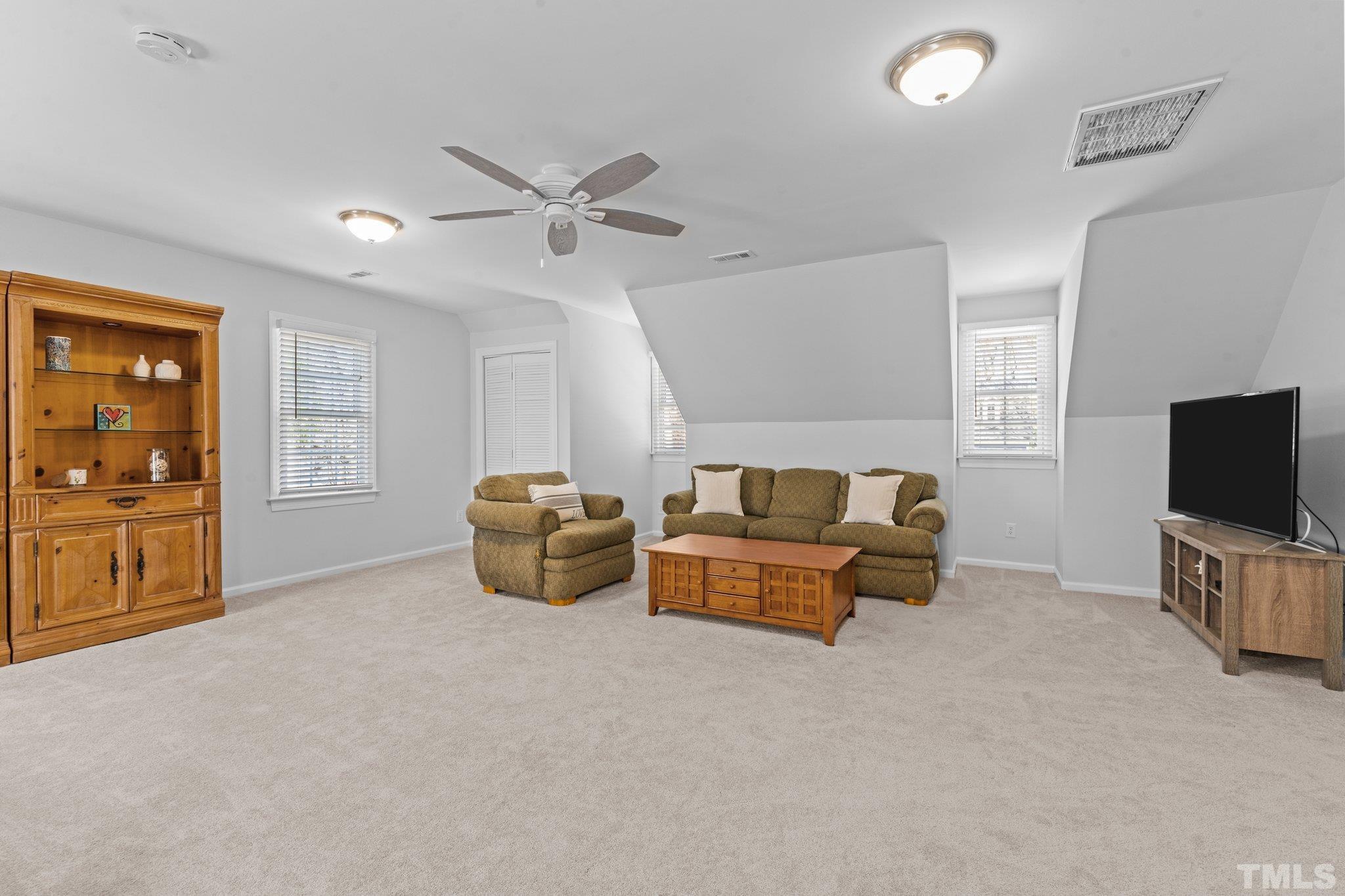 8325 Apple Orchard Way Raleigh, NC 27615 - Photo 34 of 54 a living room with furniture and a flat screen tv