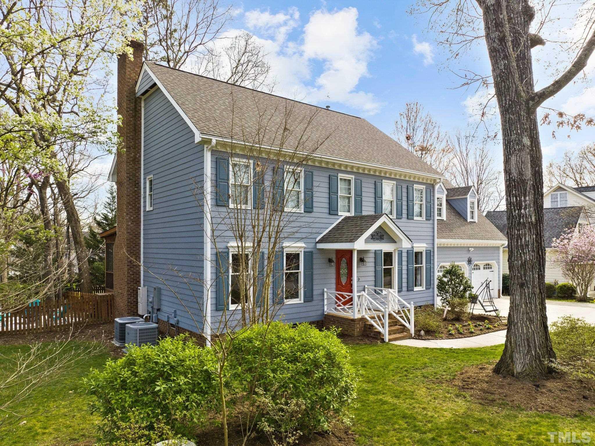 8325 Apple Orchard Way Raleigh, NC 27615 - Photo 43 of 54 a front view of a house with a yard table and chairs