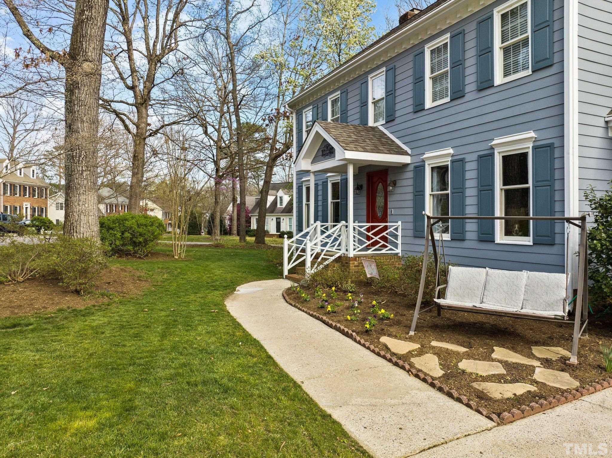 8325 Apple Orchard Way Raleigh, NC 27615 - Photo 5 of 54 a front view of a house with a yard