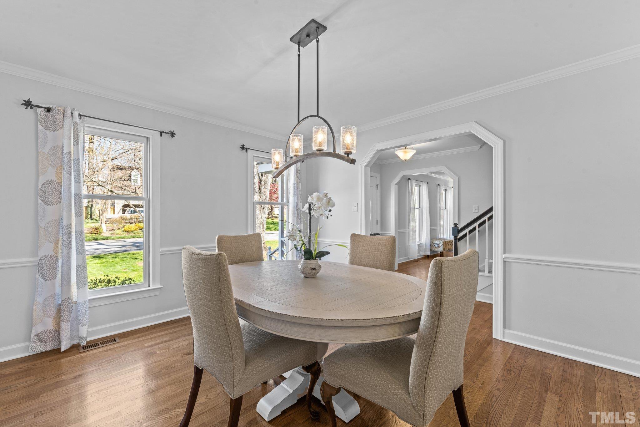 8325 Apple Orchard Way Raleigh, NC 27615 - Photo 10 of 54 a view of a dining room with furniture window and wooden floor