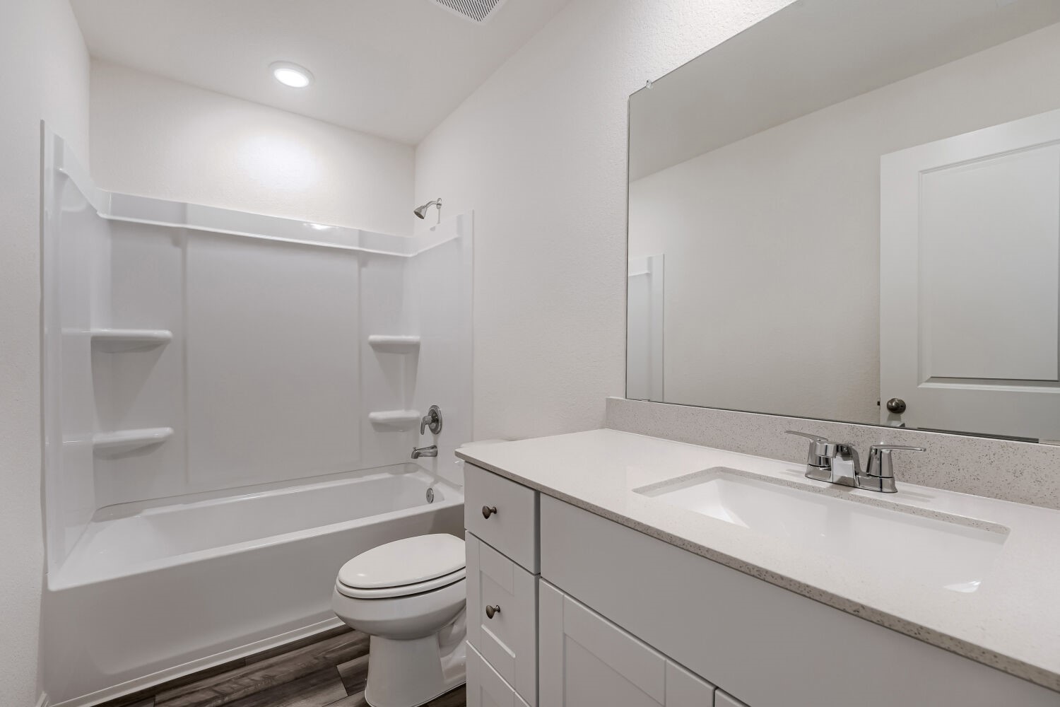 124 Mullen Way Taylor, TX 76574 - Photo 18 of 22 Contemporary bathroom featuring a white vanity with a light-toned countertop, an integrated sink, and a large wall-mounted mirror