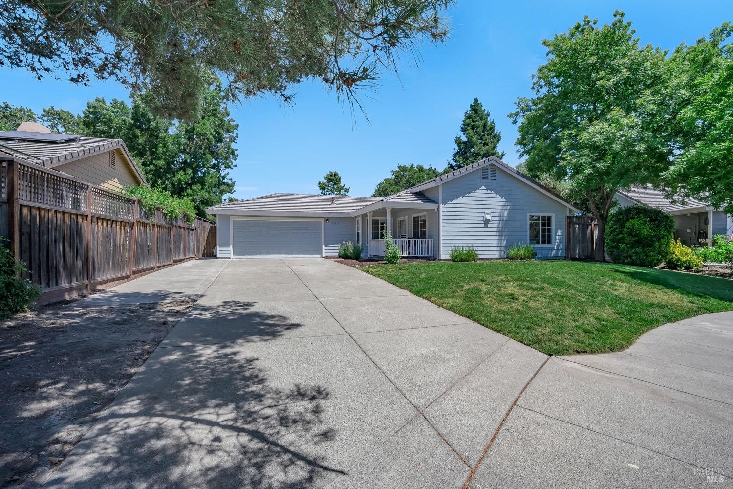 a house with green field in front of it