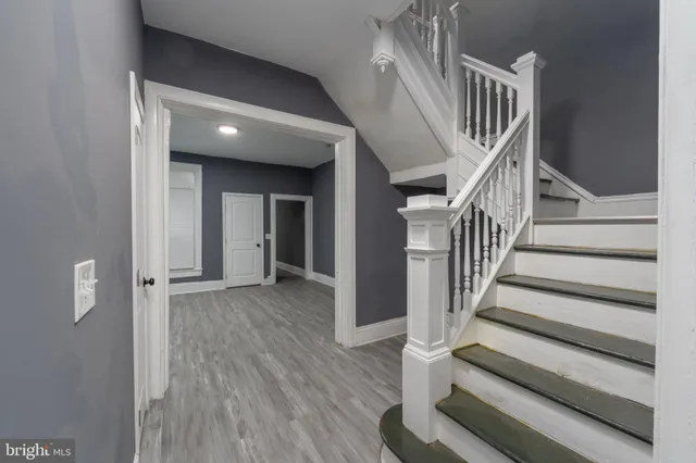 a view of staircase with white walls and railing