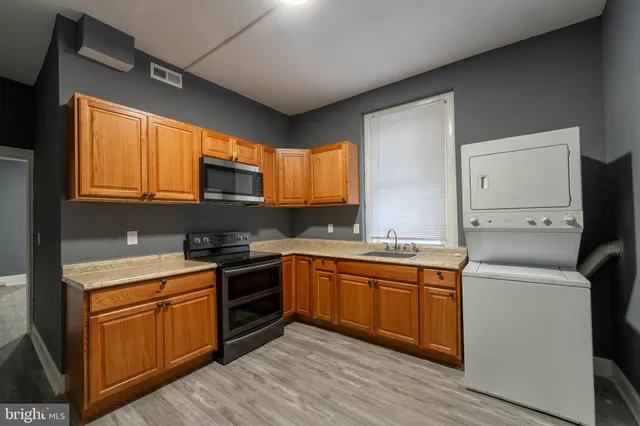 a kitchen with a sink stove and microwave