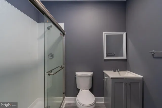a bathroom with a toilet sink and shower