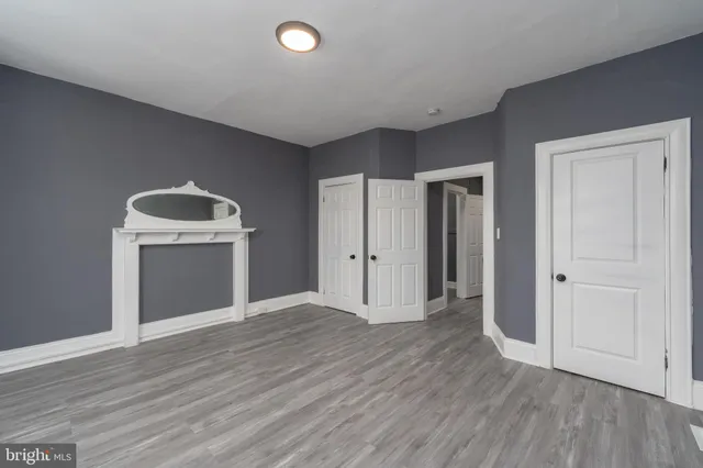 a view of a livingroom with wooden floor and a sink