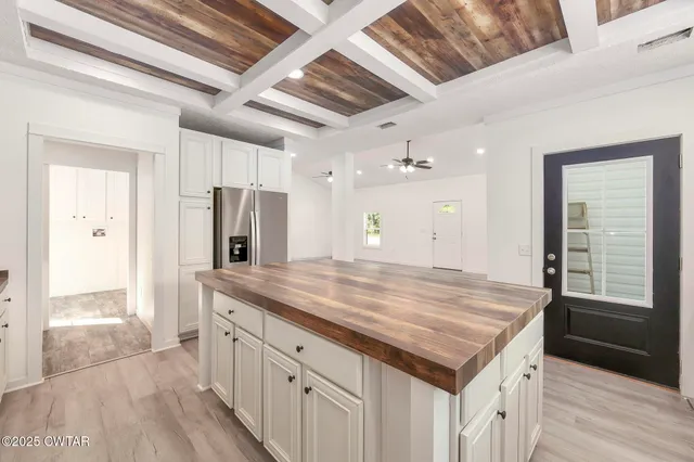 a bathroom with a granite countertop sink a mirror and a shower