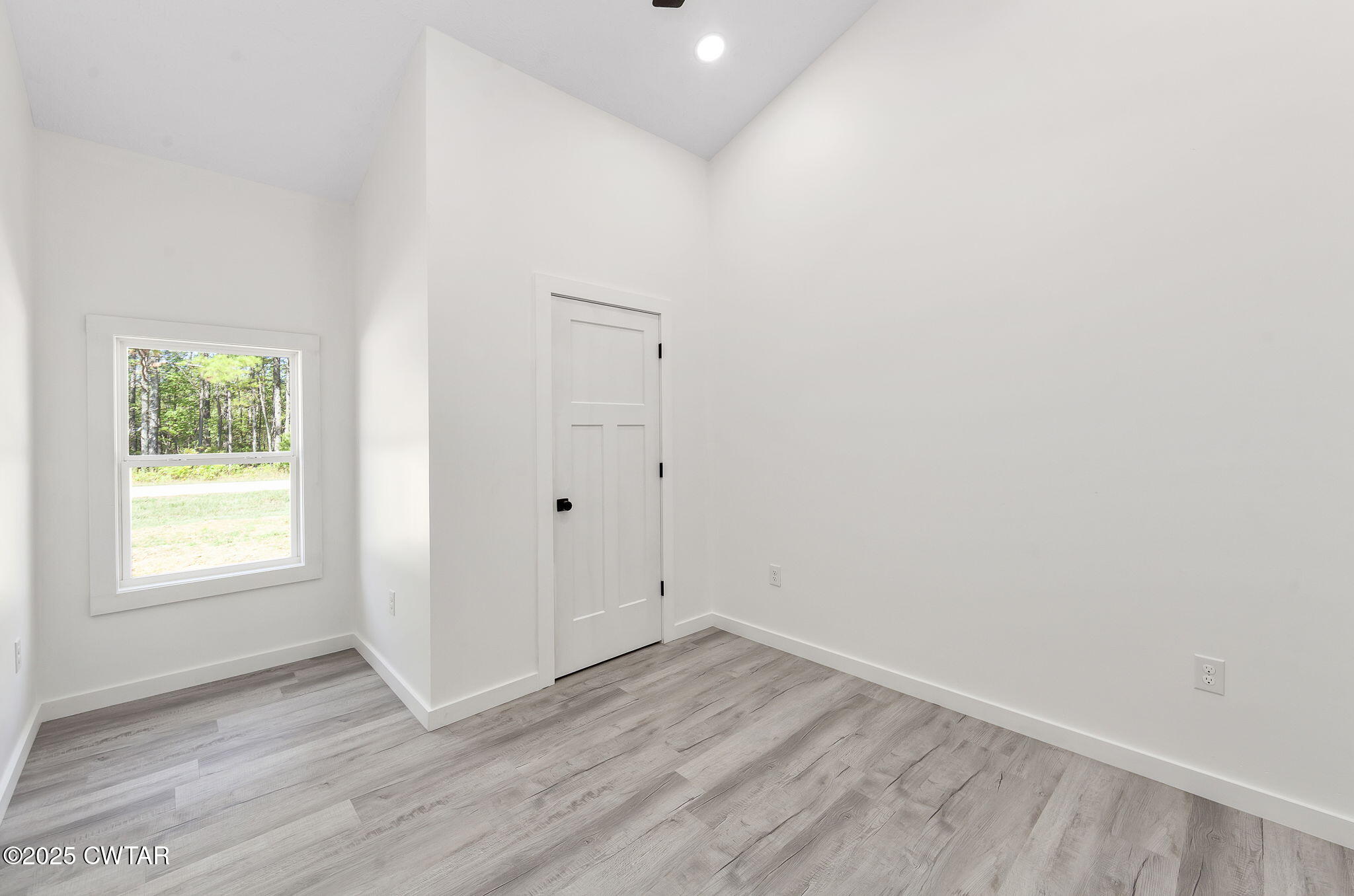 2885 Old Friendship Road Finger, TN 38334 - Photo 15 of 50 an empty room with wooden floor and windows