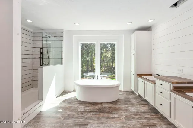 a large white kitchen with a large window