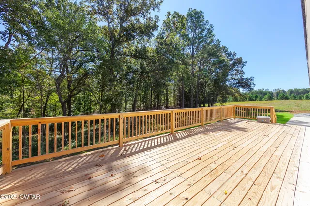a view of wooden deck and a garden