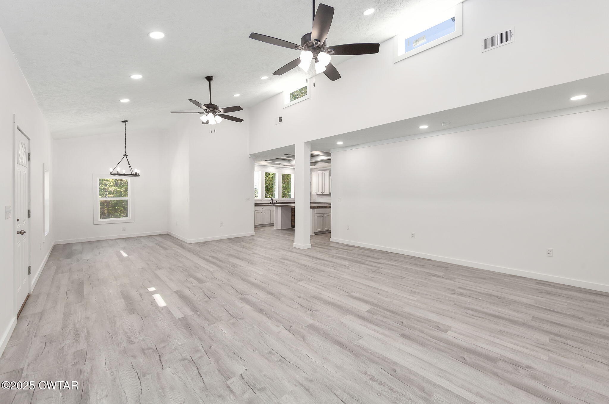 2885 Old Friendship Road Finger, TN 38334 - Photo 4 of 50 an empty room with wooden floor ceiling fan and windows